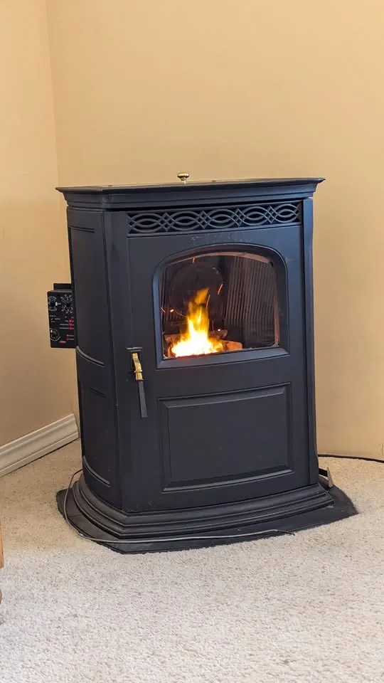 Pellet stove installed in a corner of a room